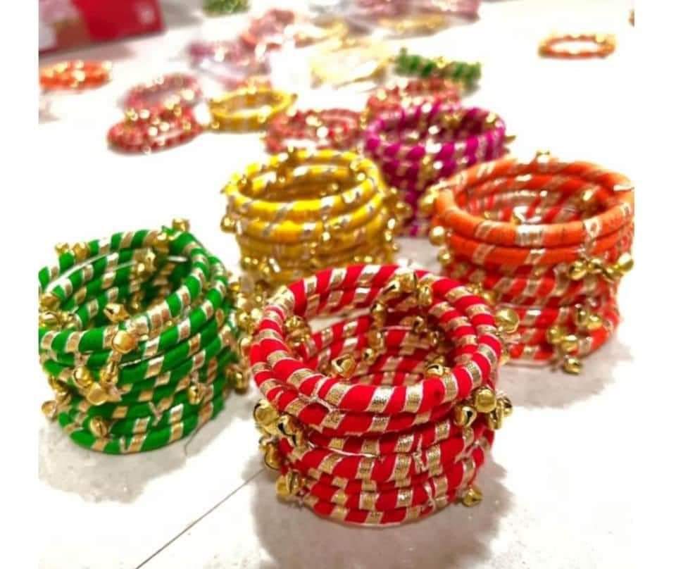 Colorful ghungroo bangles in red, green, yellow, and orange, featuring small bells and thread work, perfect for adding a traditional touch to festive outfits and Indian celebrations.